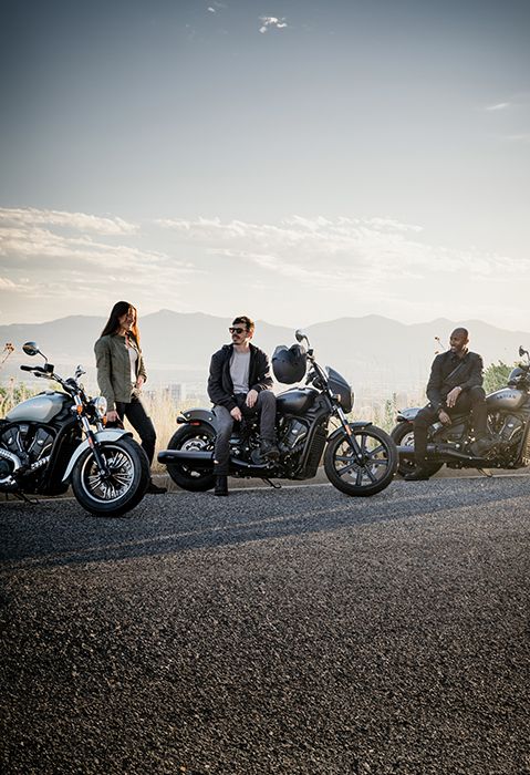 3 people with their 2025 Indian Scout cruiser-style motorcycles.
