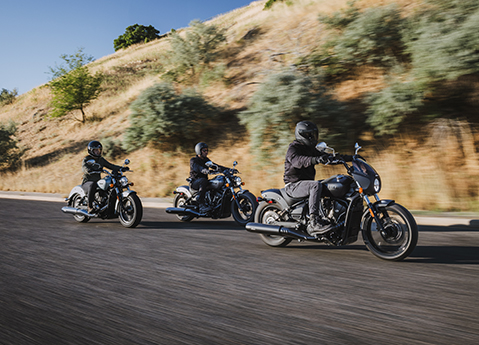 3 2025 Indian Sport Scout Sixty motorcycles cruising on the highway.