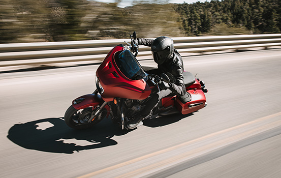 Rider speeds under bridge on an Indian Motorcycle. 