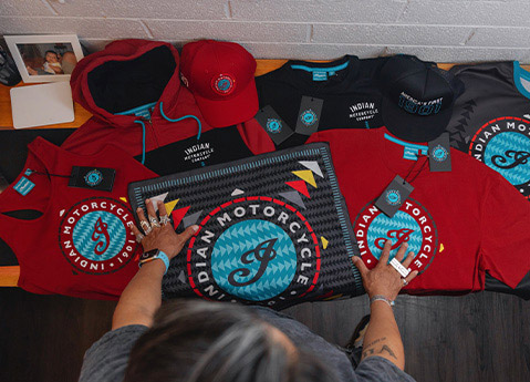 Overhead view of Jeremy Arviso standing over pieces from the Indian Motorcycle x RVSO apparel collection. 