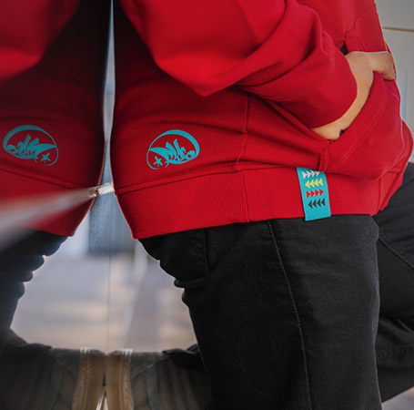 Close-up view of the turquoise detail on an Indian Motorcycle x RVSO collection sweatshirt. 