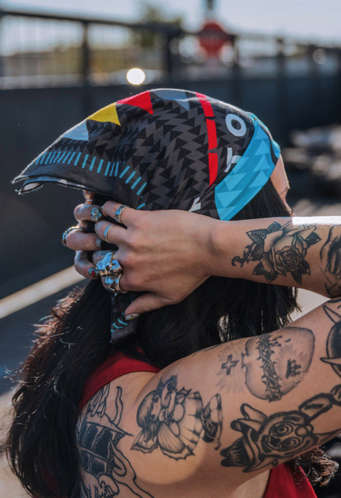 Woman wearing Indian Motorcycle x RVSO collection bandana. 