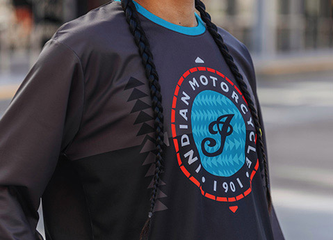 Close-up detail of Indian Motorcycle x RVSO collection long sleeve racing shirt. 