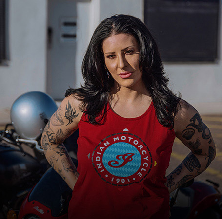 Woman wearing Indian Motorcycle x RVSO tank. 
