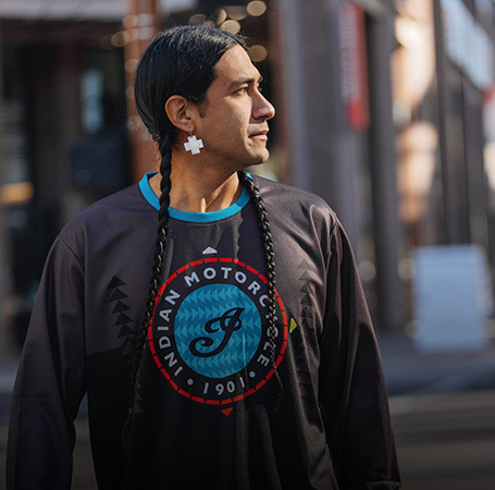 Man wearing Indian Motorycle x RVSO racing long sleeve t-shirt. 