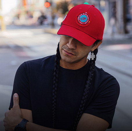 Man wearing Indian Motorcycle x RVSO embroidered patch cap. 