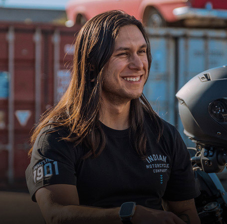 Man wearing Indian Motorcycle x RVSO printed t-shirt. 