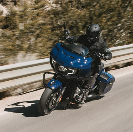 Rider takes sharp bend on an Indian Motorcycle with upgraded performance accessories. 