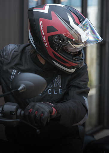 Side view of a man wearing an Indian Motorcycle helmet. 