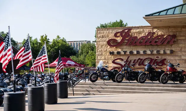 Indian Motorcycles display at Sturgis Motorcycle Rally, featuring ScoutModel on elevated platform.