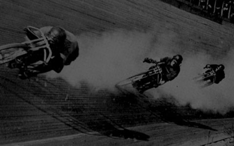 Historic black and white image of motorcycle race in 1903.
