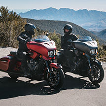 2 riders on their Indian bagger motorcycles chatting before a ride.