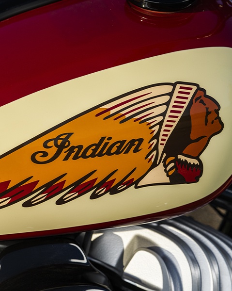 Close-up of the Chief Vintage - Sturgis, SD Edition fuel tank featuring a red and cream finish with Indian Motorcycle head logo