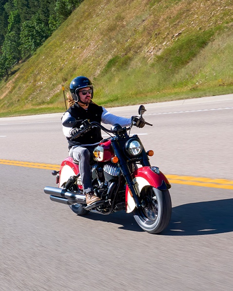 Man riding on a Chief Vintage Sturgis, SD Edition Indian Motorcycle on a desert highway.