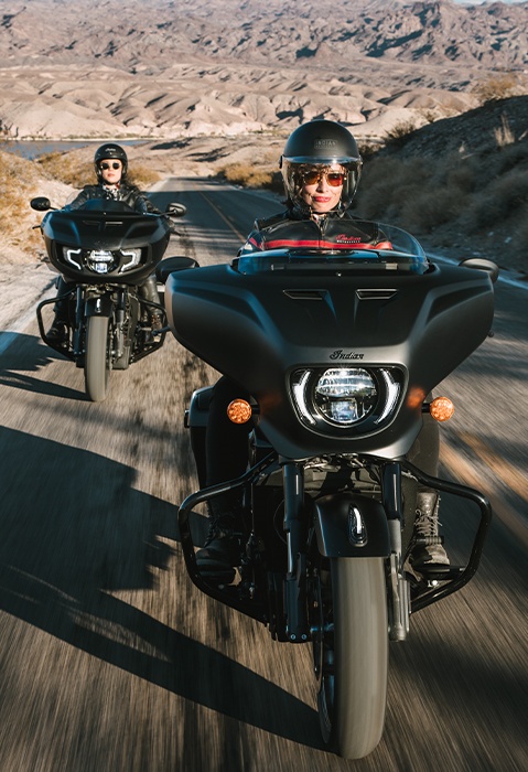 2 people riding Indian Chieftain PowerPlus bagger motorcycles down the highway.