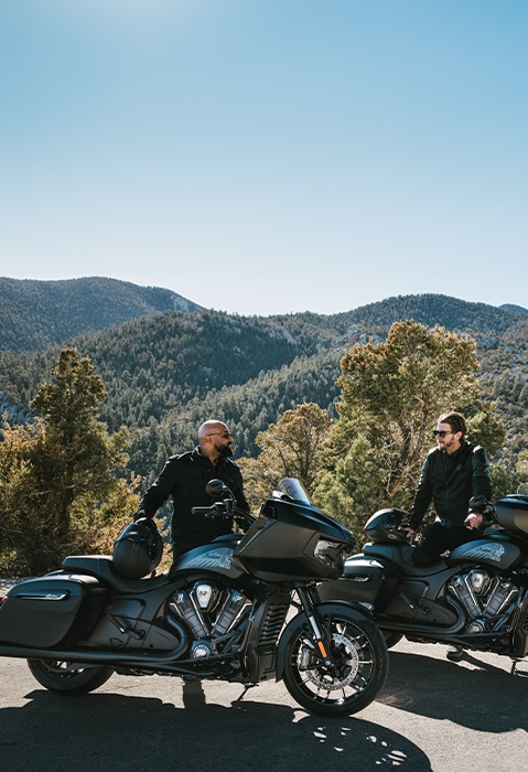 2 men preparing to ride their Indian Challenger motorcycles.