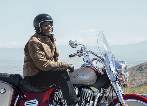 A man with a helmet sitting on a 2026 Indian Springfield bagger motorcycle.