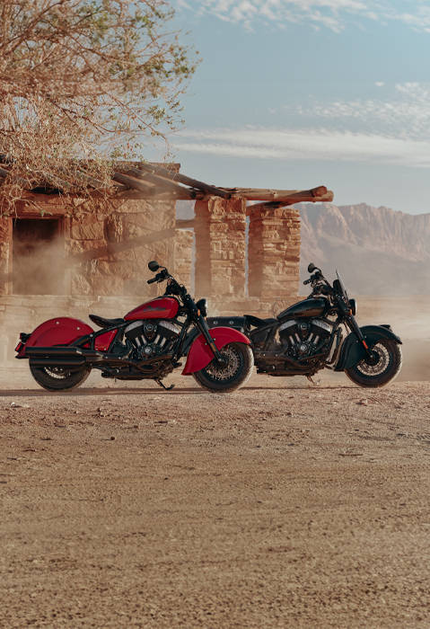 Two 2026 Indian Chief Vintage motorcycles parked near each other in the desert.