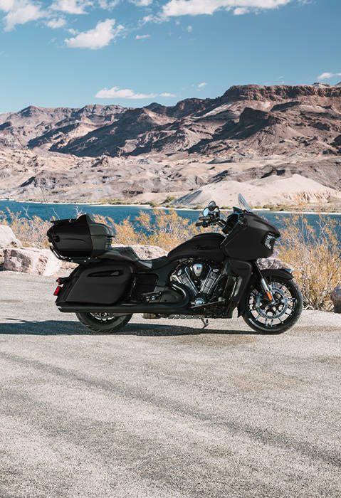Side profile of a 2026 Indian Pursuit Dark Horse touring motorcycle in the black smoke colorway. 