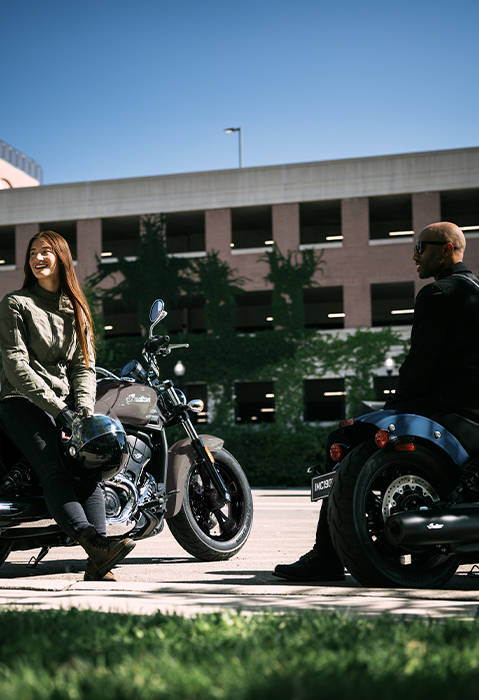 A woman sitting on a 2026 Indian Scout Sixty Classic cruiser motorcycle. 