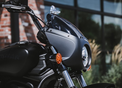 Closeup of the headlight, windshield, and fairings on a 2026 Indian Sport Scout Sixty cruiser motorcycle.