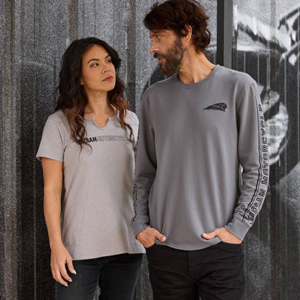 Woman and man having conversation while wearing Indian Motorcycle apparel. 
