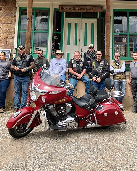 United States Army men sitting behind an Indian Motorcycle.