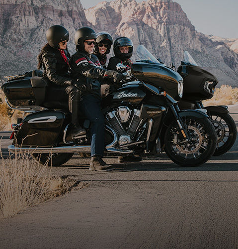 Couple riding on an Indian Motorcycle through mountains while using Motorcycle Ride Assist Technology. 