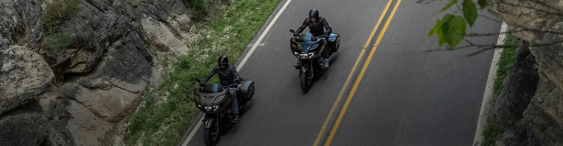 Overhead shot of Bagger Indian Motorcycles cruising on roadway.