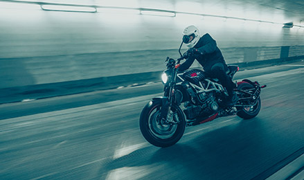 Naked Indian Motorcycle cruising on road.