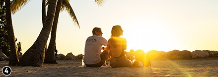 Couple wearing Indian motorcycle clothing, enjoying the sunset in daytona beach, florida