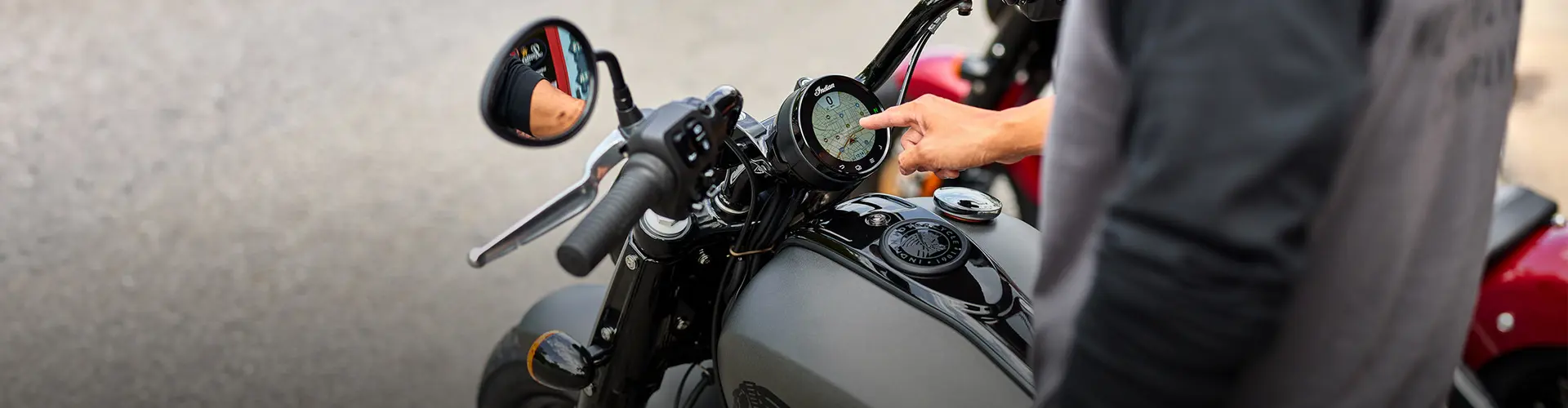 Man points at GPS touchscreen technology on an Indian Motorcycle. 