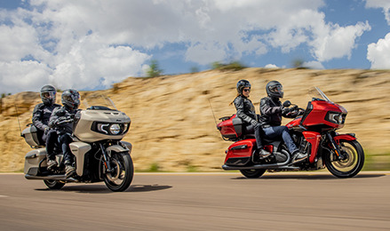 Two groups of riders on their Indian Pursuit Dark Horse motorcycles.