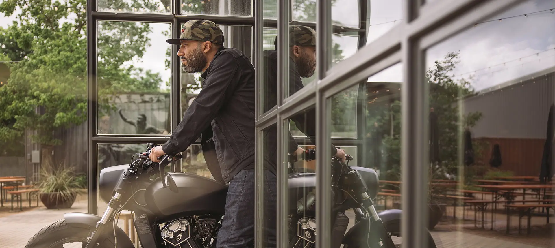 Man pulling motorcycle out