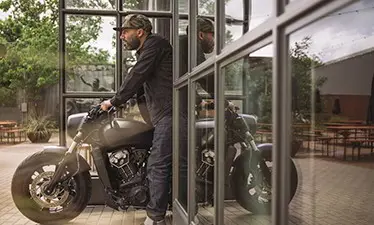 Man pulling motorcycle out