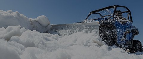 Offroad vehicle plowing snow