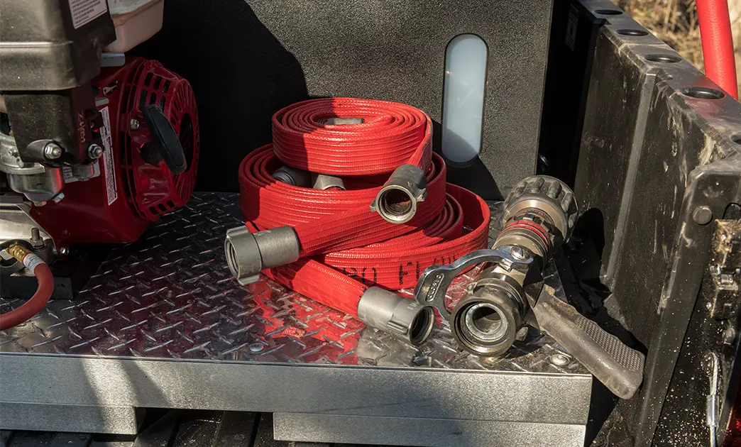 fire hose in the cargo box of a polaris ranger UTV