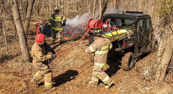 fire crew using hose on the fire rescue kit on a polaris ranger