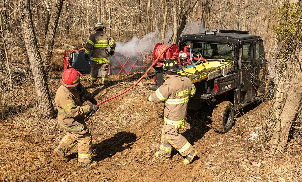 fire crew using hose on the fire rescue kit on a polaris ranger