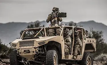 soldiers scoping out the environment in a fully loaded dagor a1 tactical vehicle