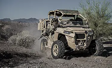 2 soldiers in a mrzr diesel tactical vehicle