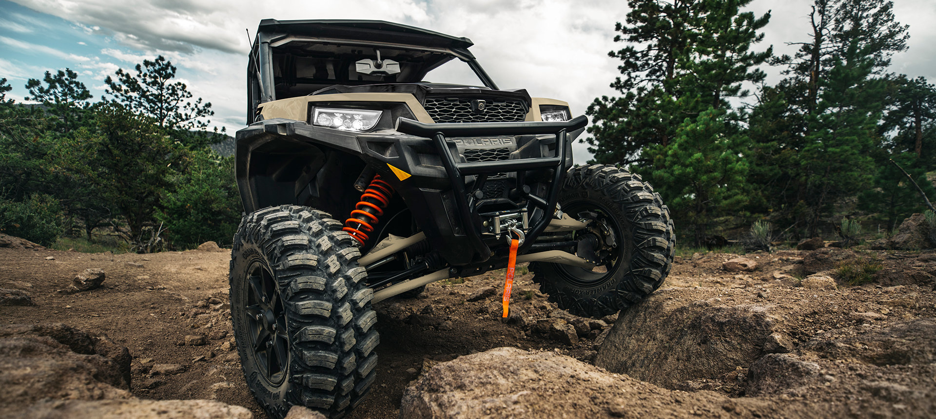 General XP 1000 vehicle riding over dirt rocks