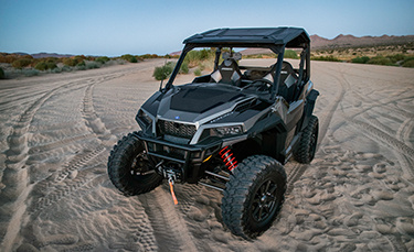 General XP 1000 parked on a road in the sand