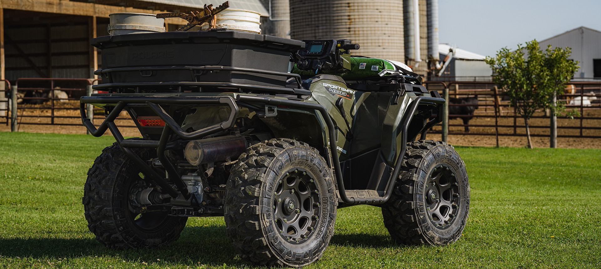 Close view at the rear of a Sportsman 450 in a green field