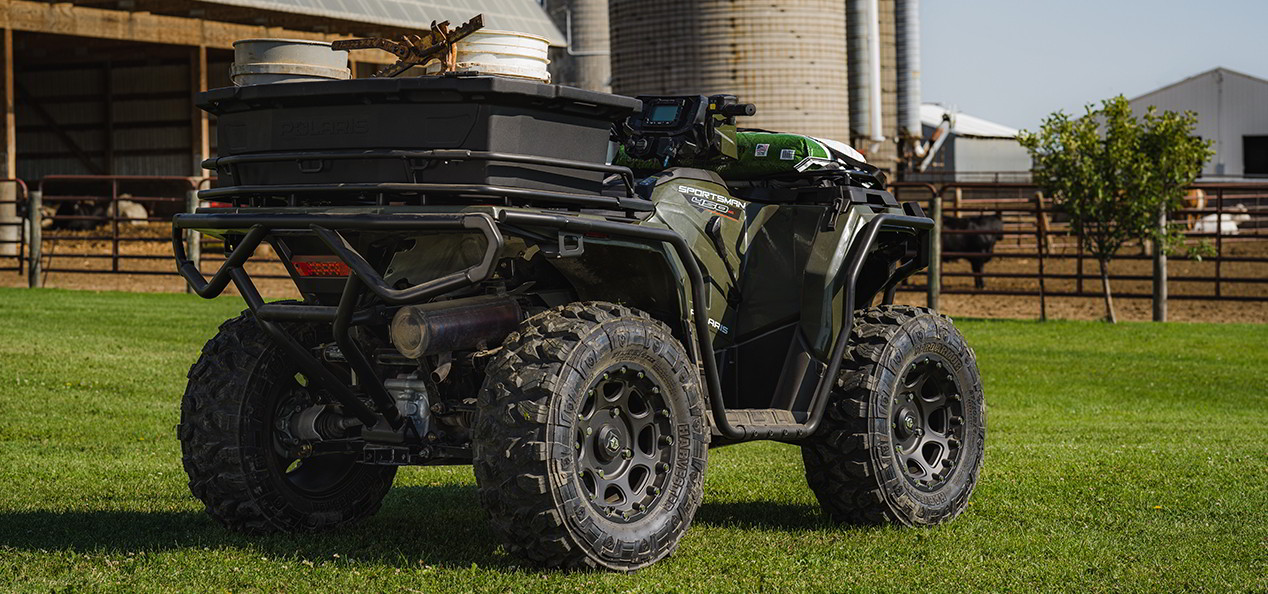 Close view at the rear of a Sportsman 450 in a green field