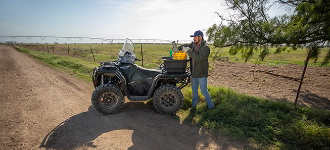 Sportsman 450 and its owner loading the storage box