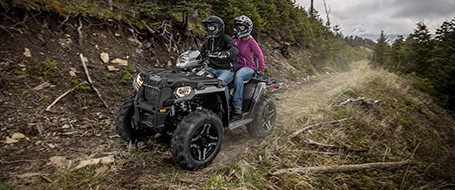 Two Sportsman 570 riders on the road