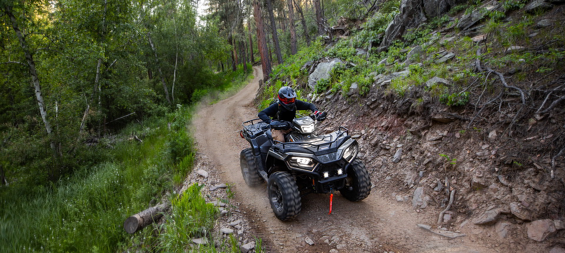Sportsman 570 on a trail road