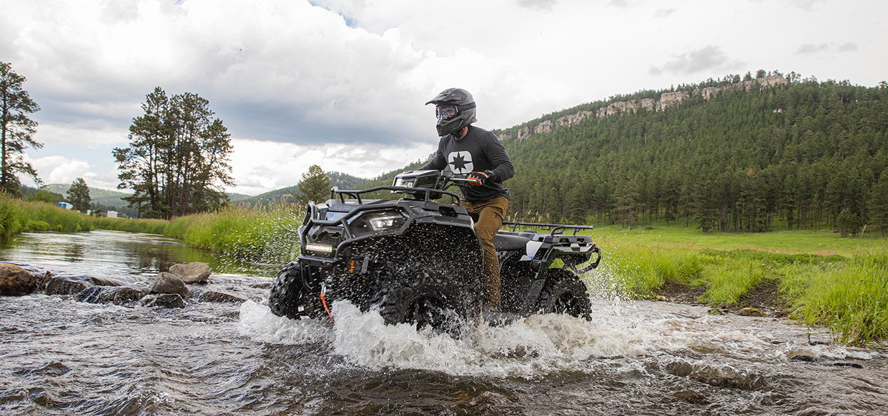 Sportsman 570 crossing a river