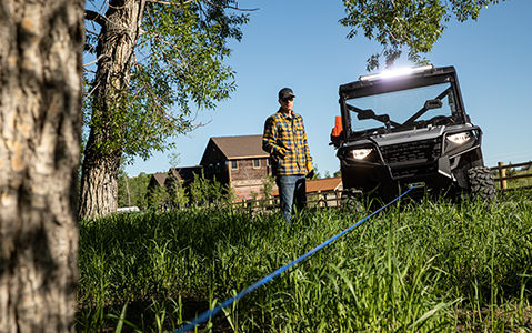 man using the hard working winch on the polaris ranger sp 570
